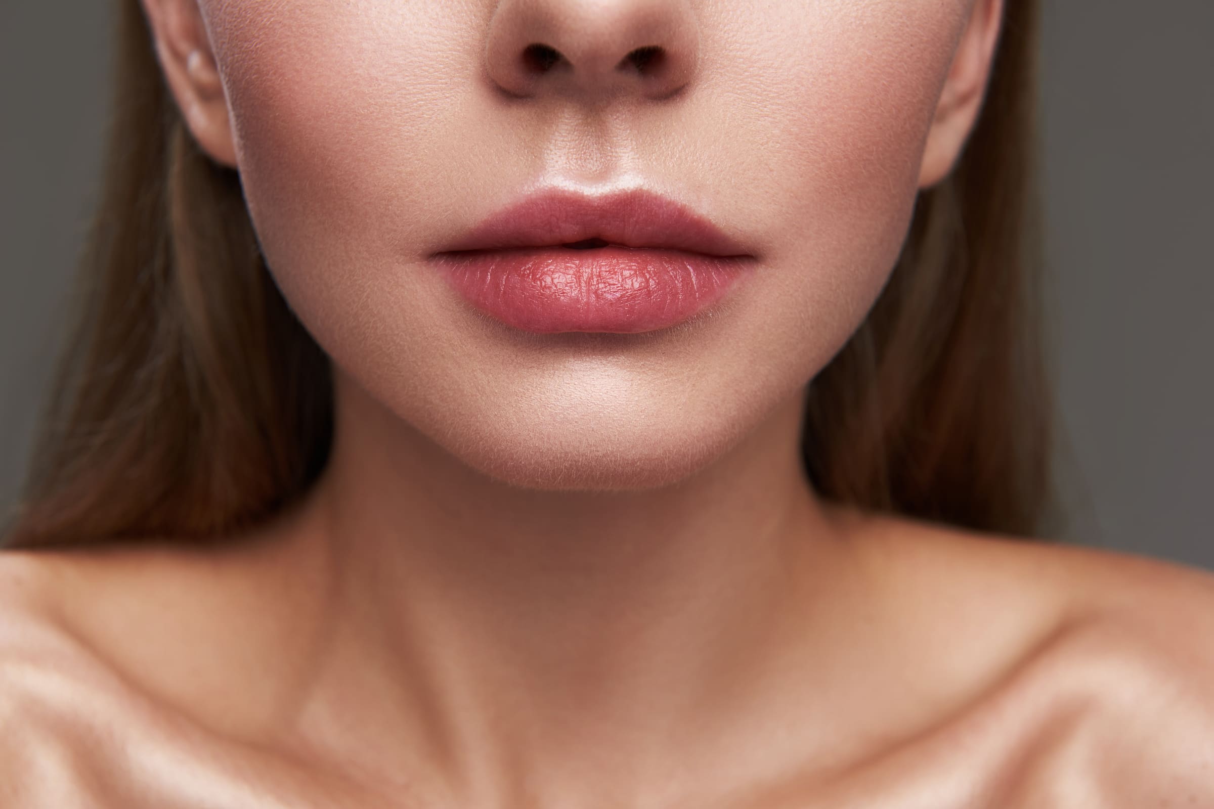 Close up of a woman’s full, natural lips and chin